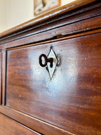 Close-up of a wooden surface with a logo or emblem on it