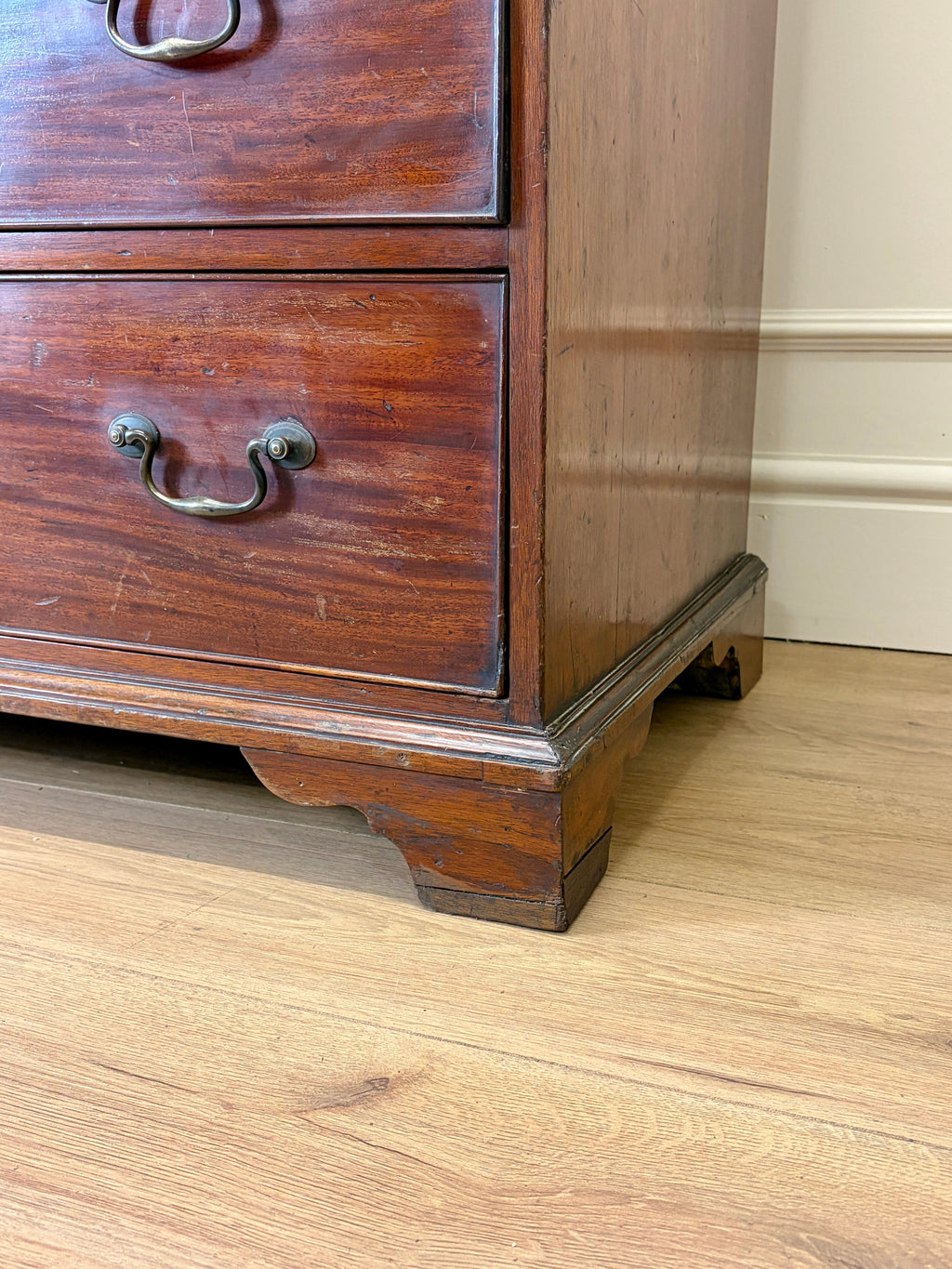 Wooden dresser with a drawer on a wooden floor