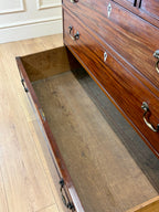 Wooden dresser with a pull-out panel on a wooden floor
