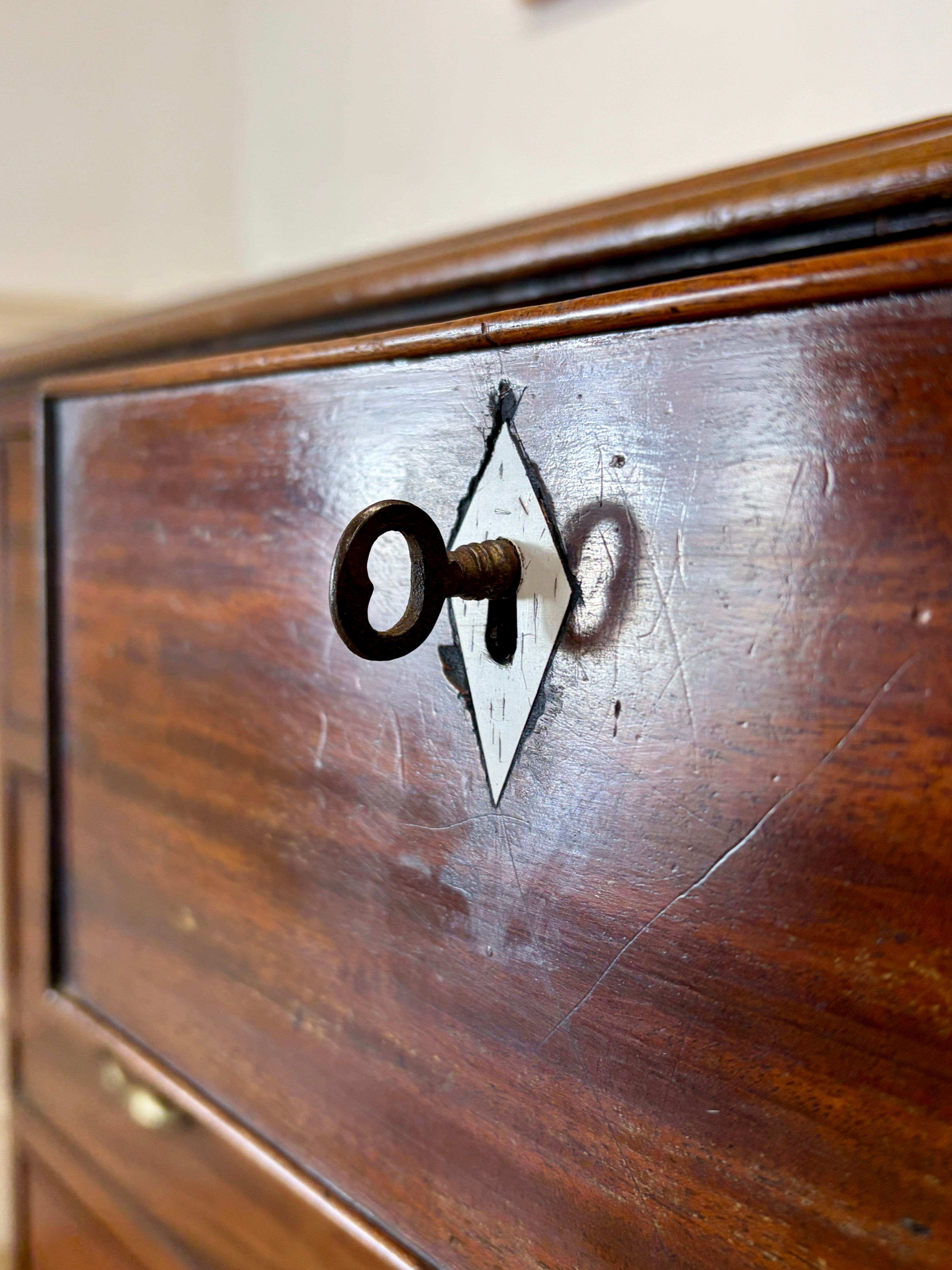 Wooden drawer with a keyhole and key on a wooden surface