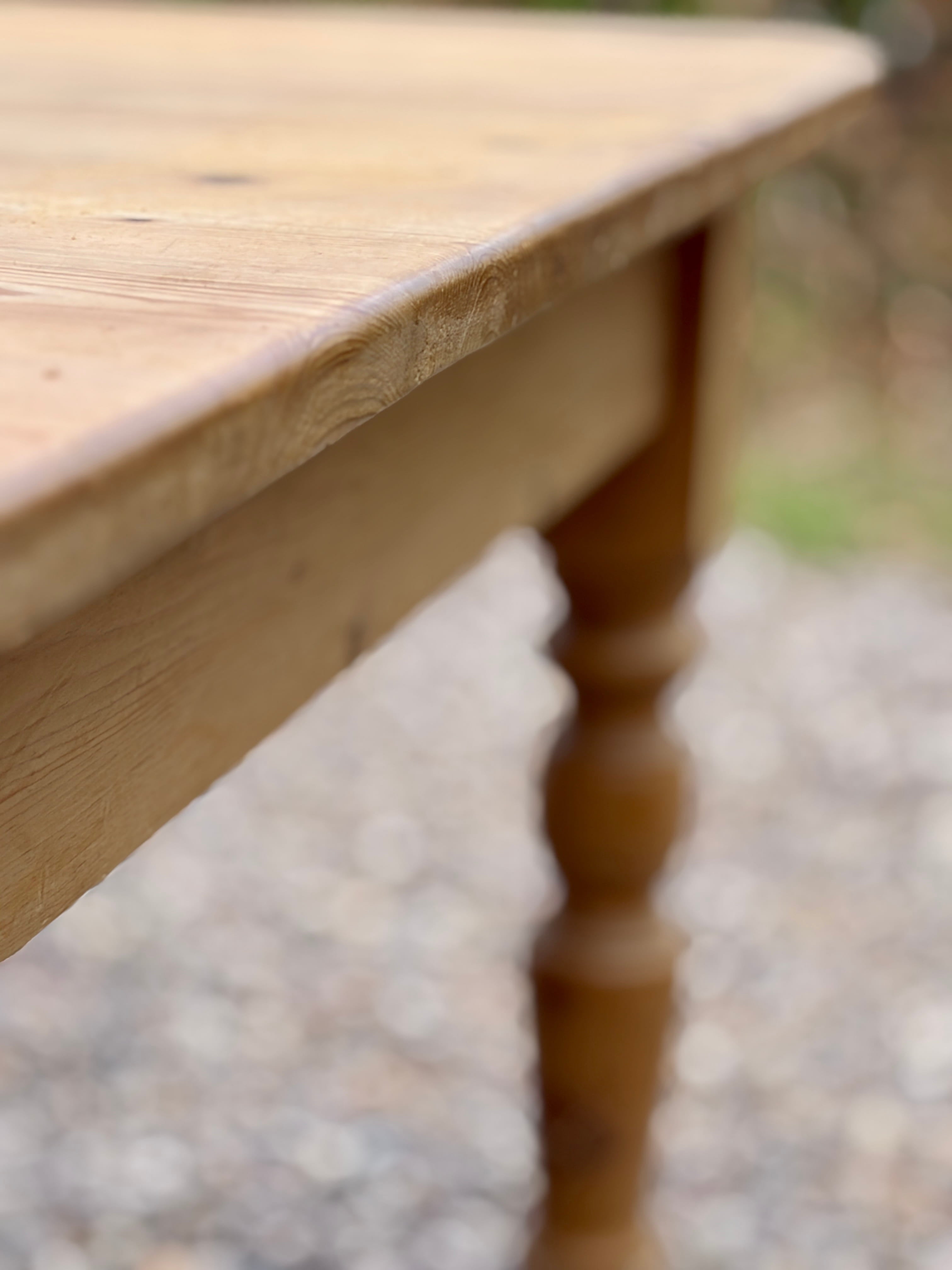 Close-up of a wooden table with a blurred background