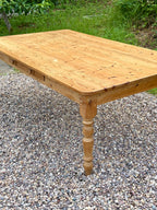 Wooden table on a gravel surface with grass in the background