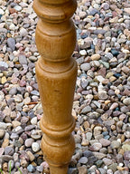 Wooden spindle on a bed of multicolored pebbles