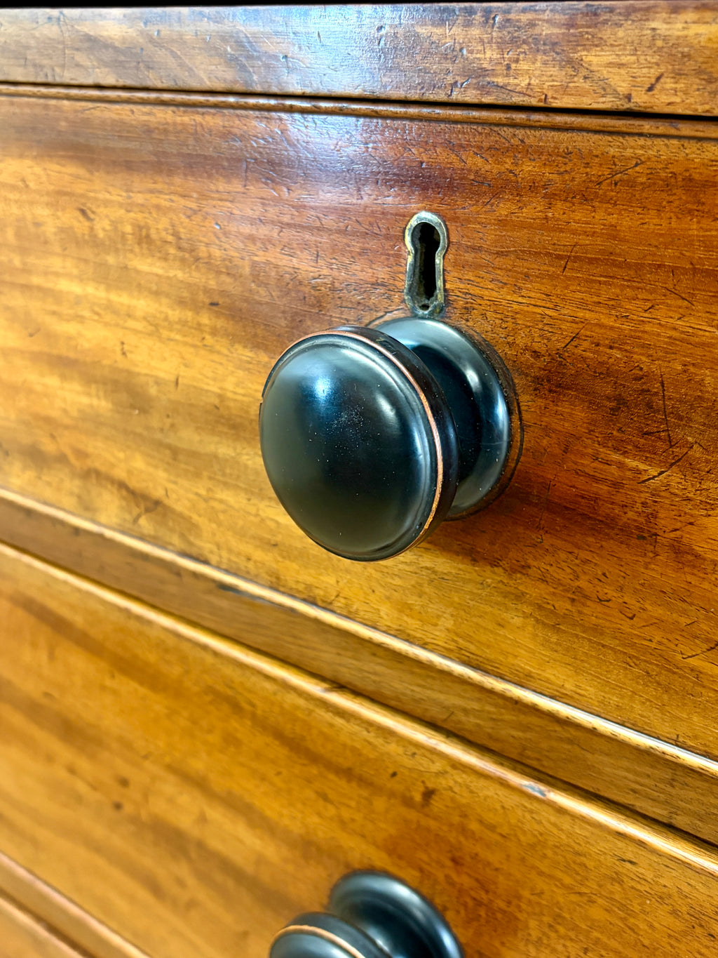 Wooden drawer with a metal handle and keyhole