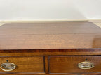Wooden desk with two drawers and brass handles on a white background