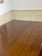 Wooden table with wainscoting in the background