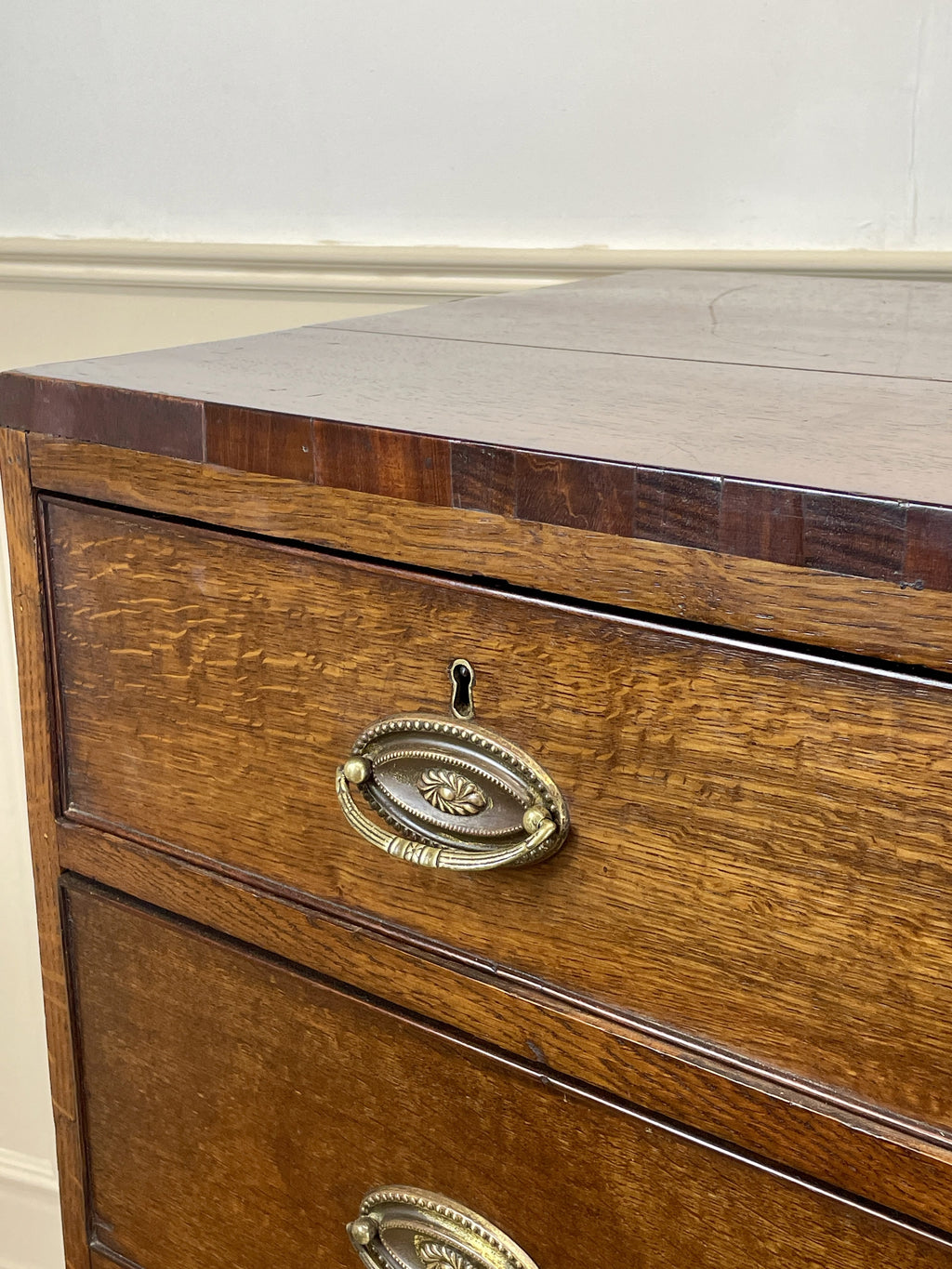 Wooden drawer with brass handle on a white background