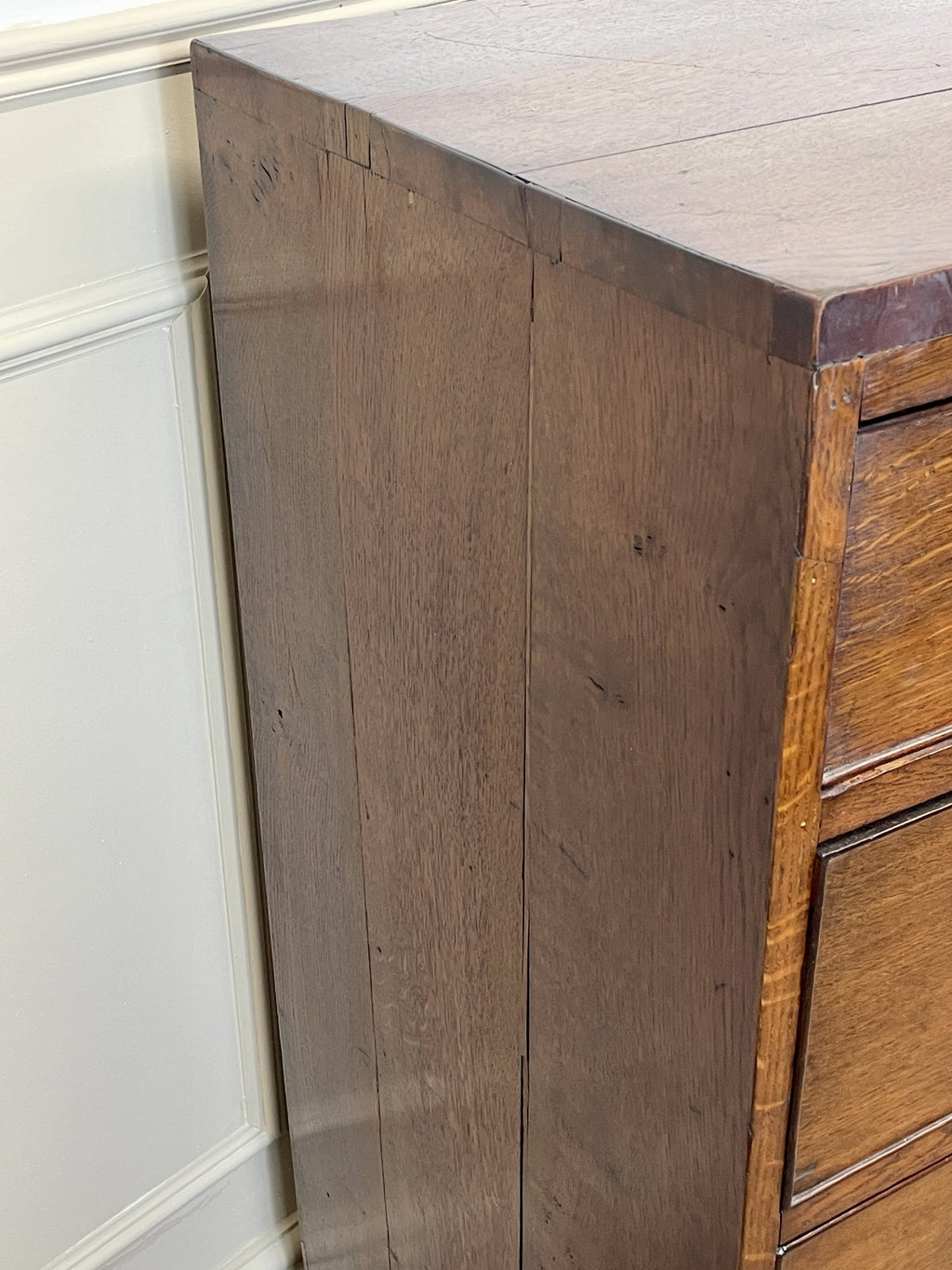 Wooden cabinet with a white wall background