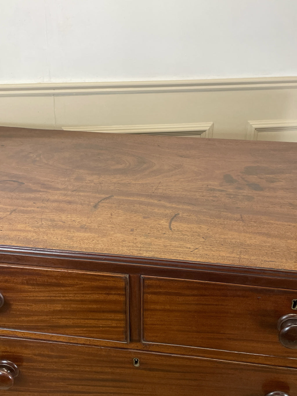 Wooden dresser with two drawers in a room setting