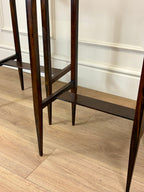 Wooden shelf against a white wall with wooden floor