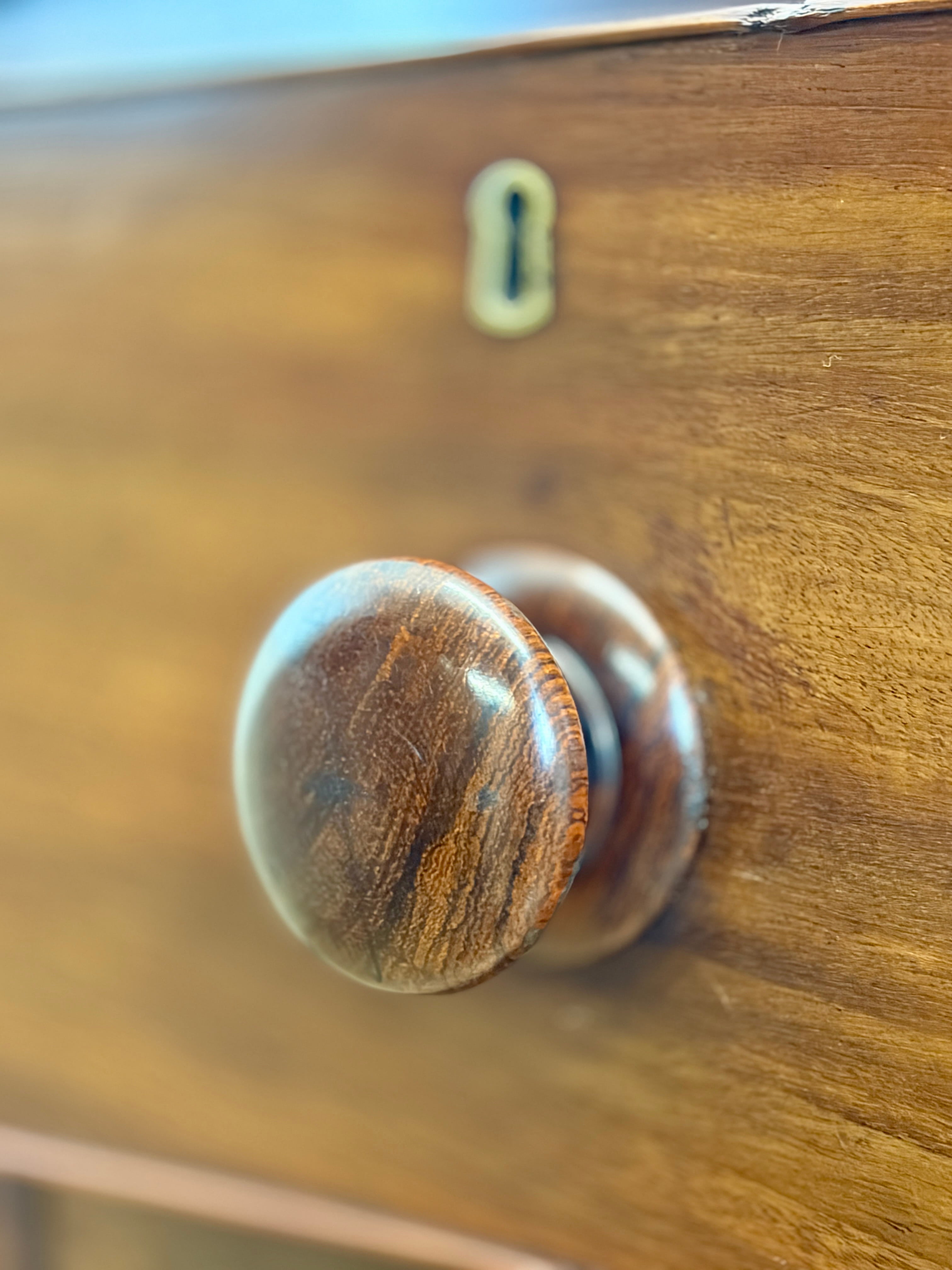 Wooden door handle on a wooden drawer