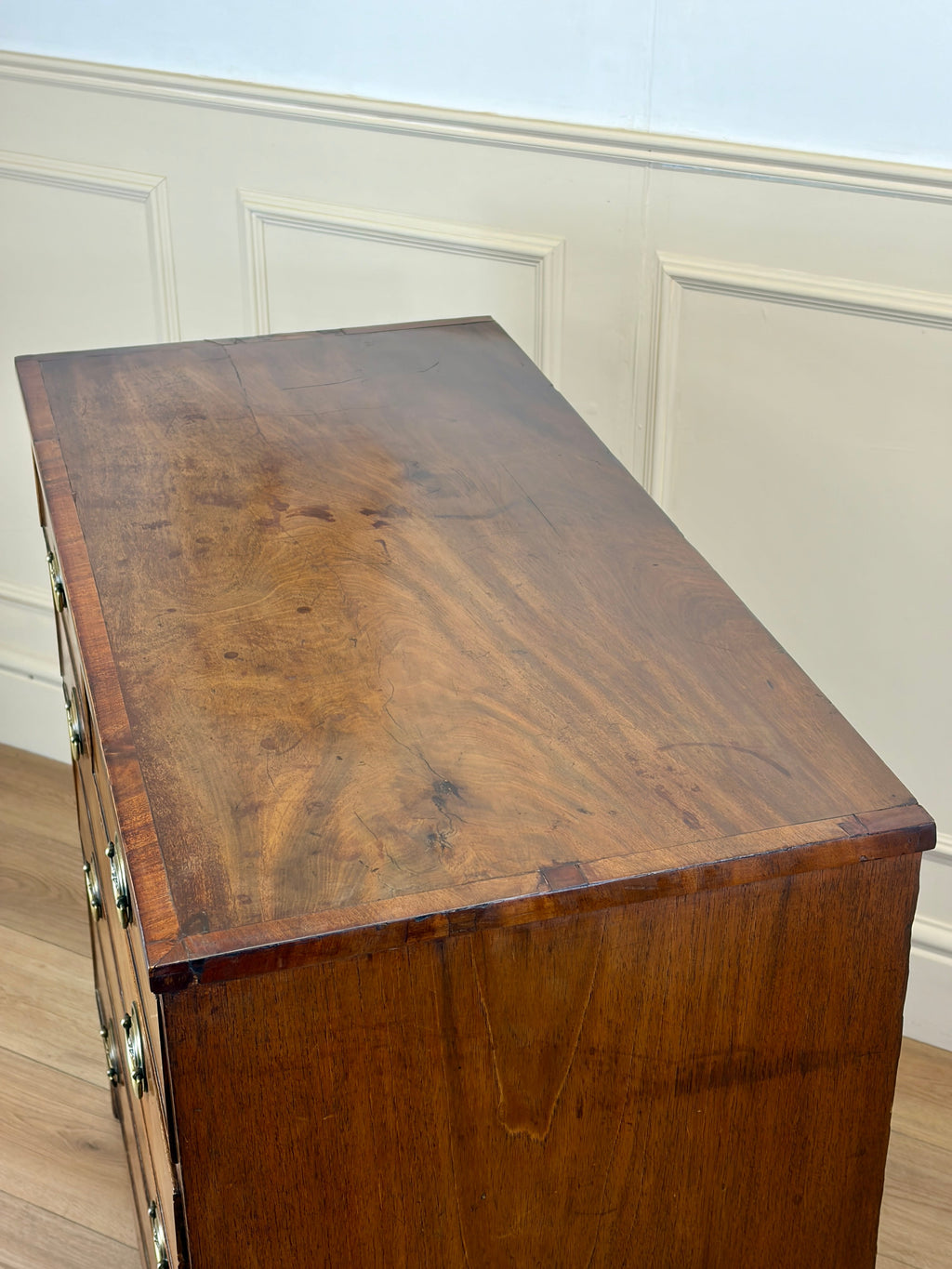 Wooden desk with a wainscoted wall in the background
