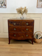 Wooden dresser with decorative items on a wooden floor