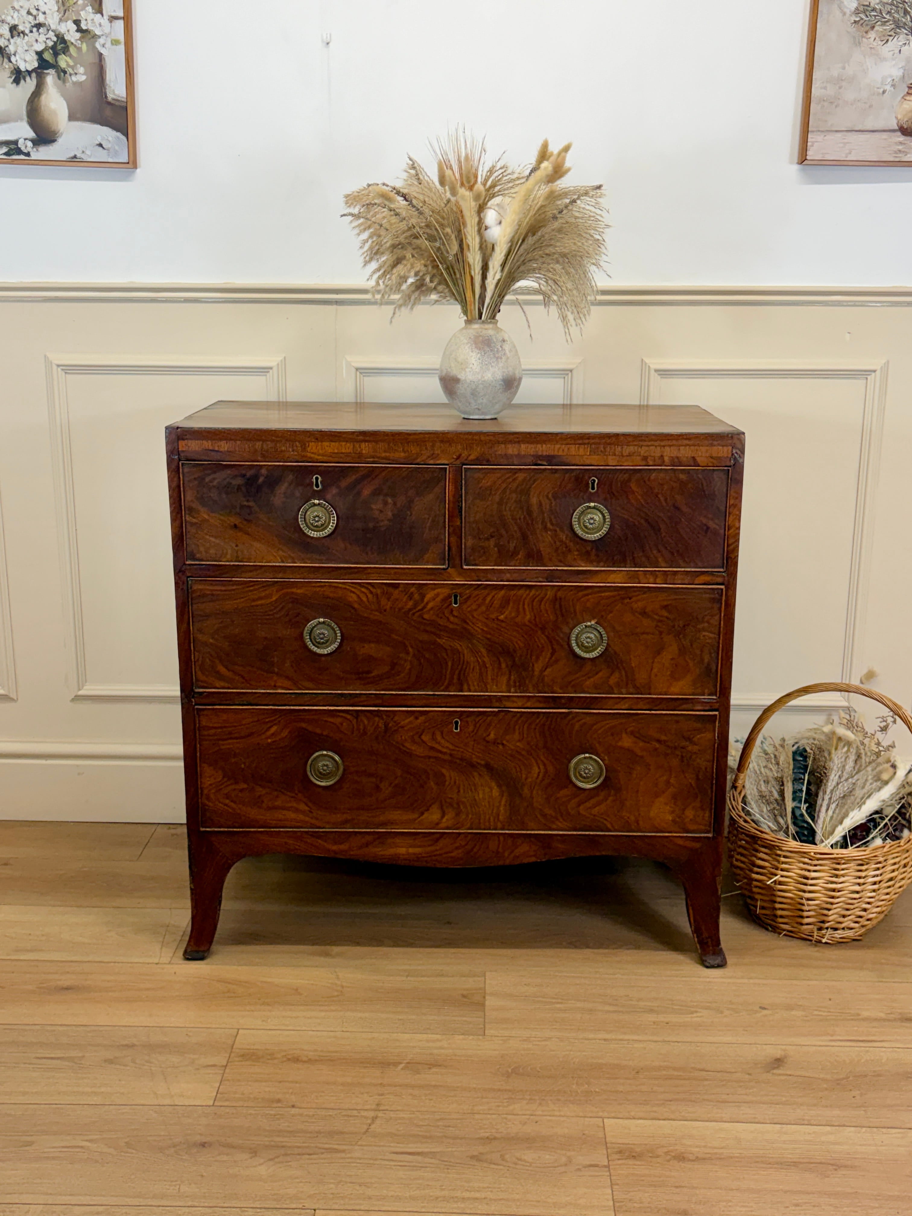 Wooden dresser with decorative items on a wooden floor