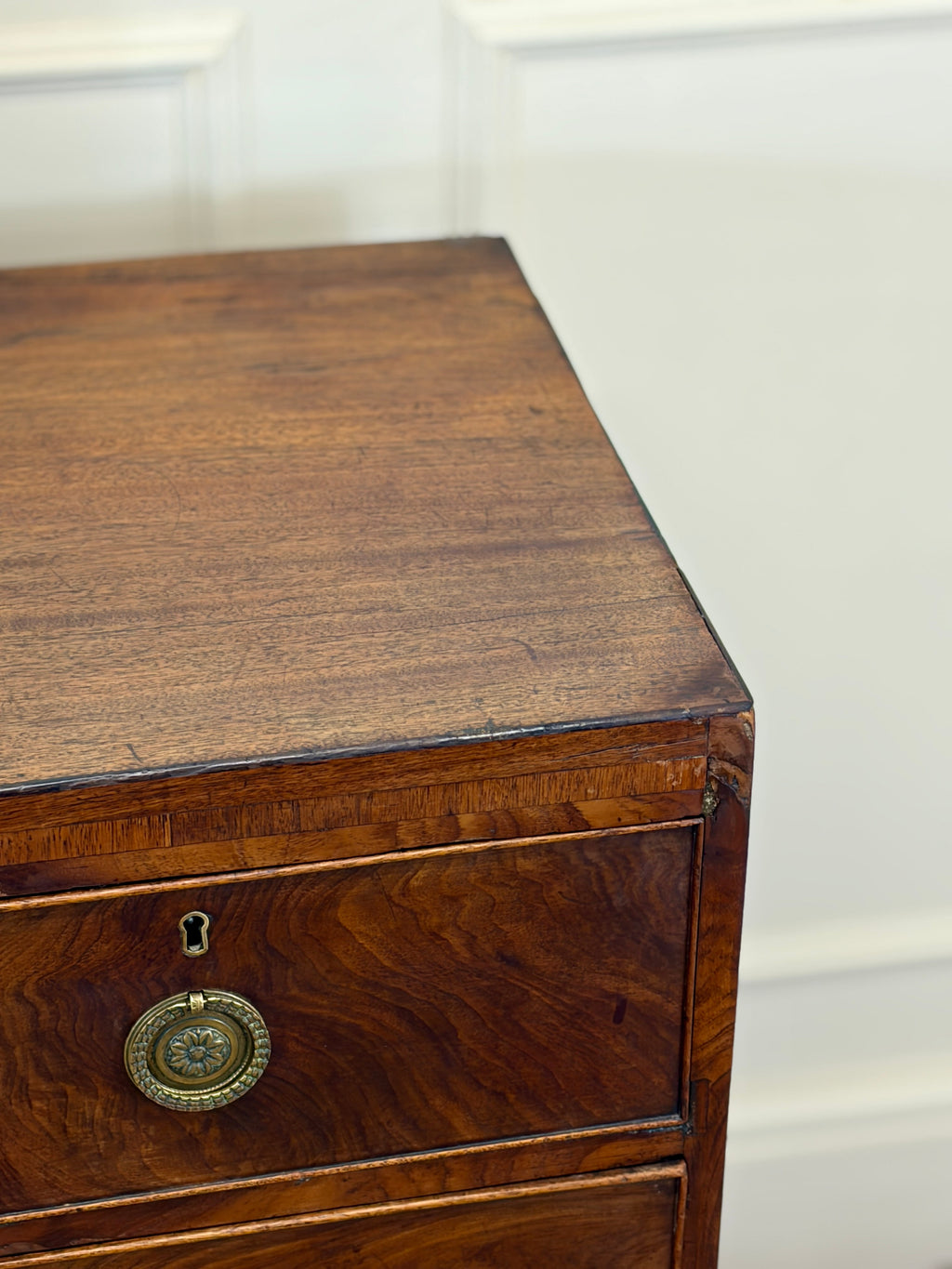 Wooden drawer with brass handle on a white background