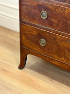 Wooden dresser with decorative buttons on a wooden floor