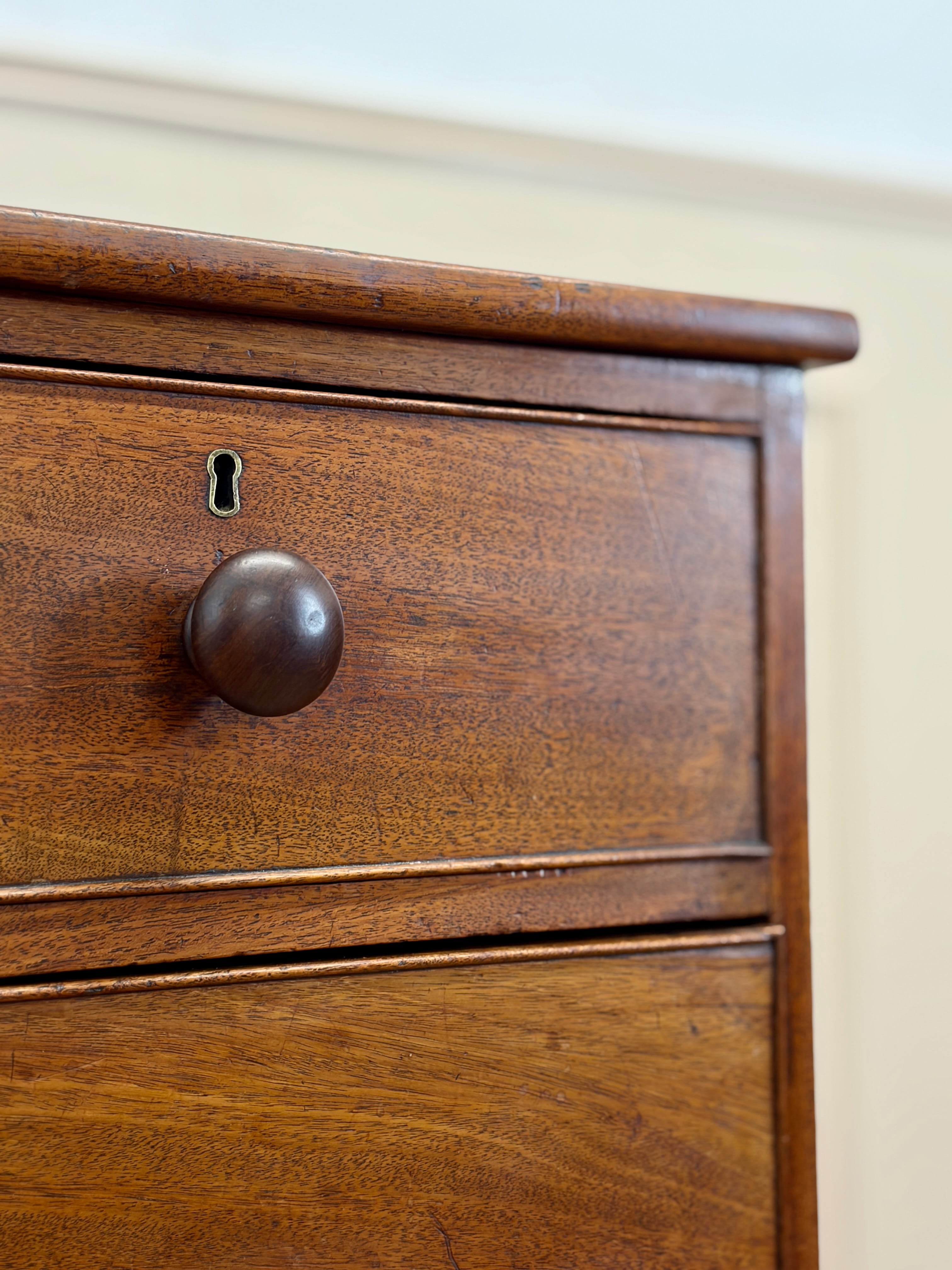 Close-up of a wooden drawer with a knob and keyhole.