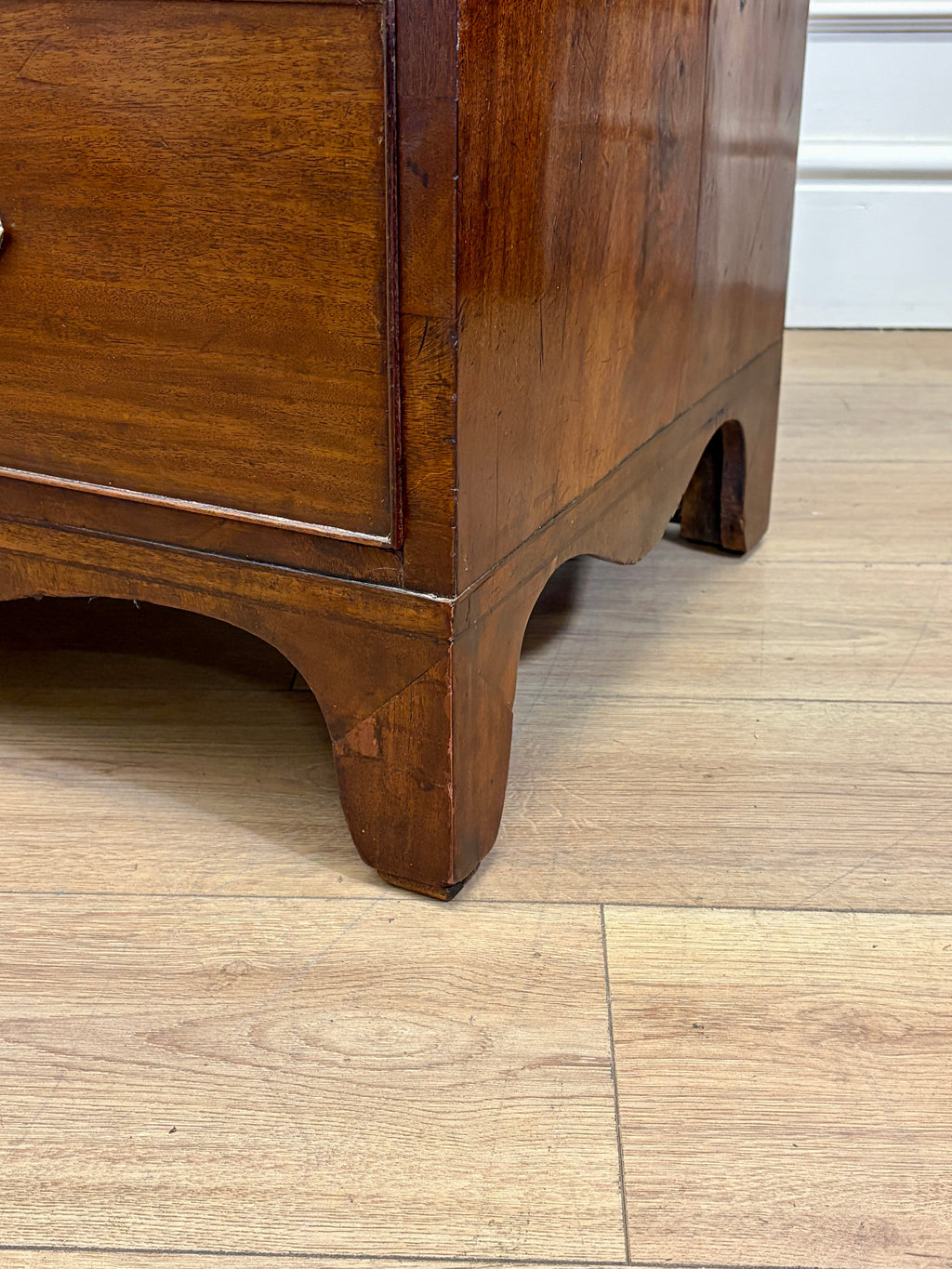 Wooden dresser corner on a wooden floor