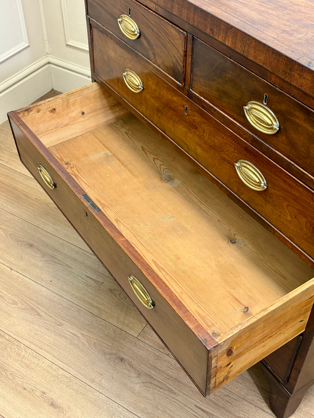 Wooden desk with glass top on a wooden floor