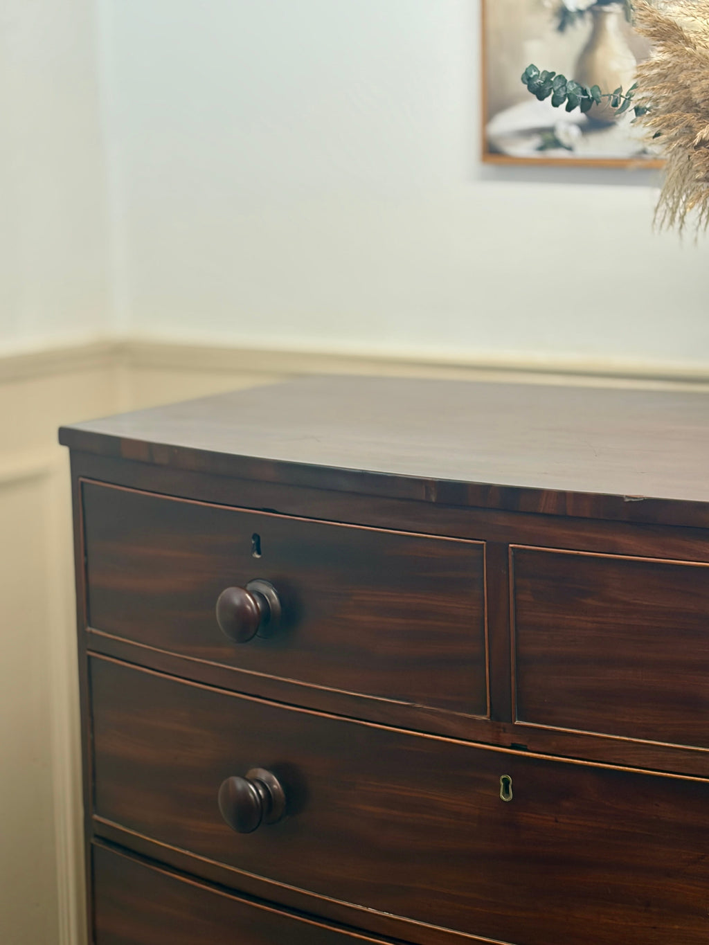 Wooden dresser with three drawers in a room setting