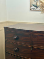 Wooden dresser with three drawers in a room setting