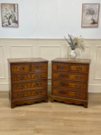 Two wooden dressers with drawers against a wall with decorative elements.