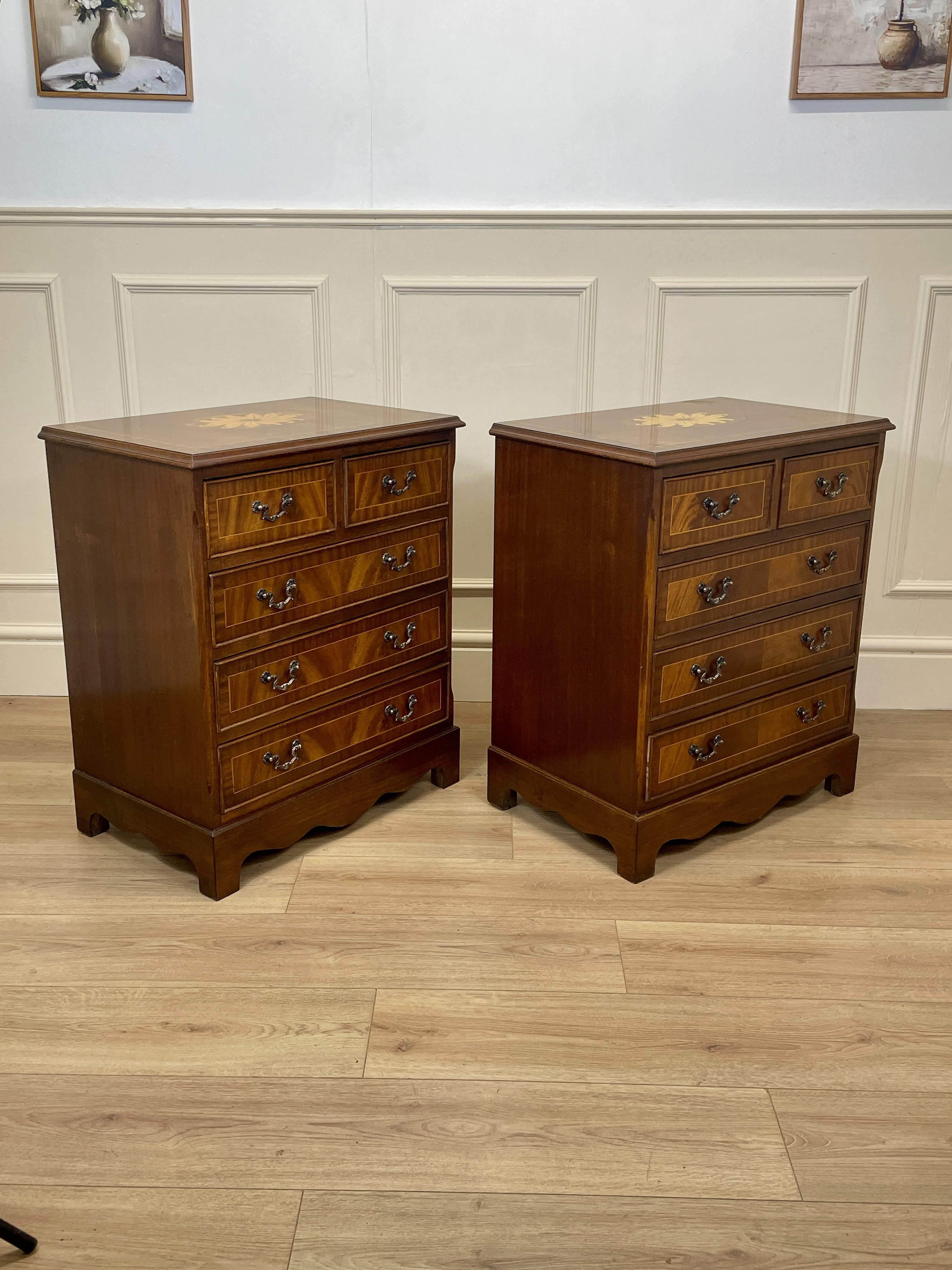 Two wooden nightstands with multiple drawers on a wooden floor.